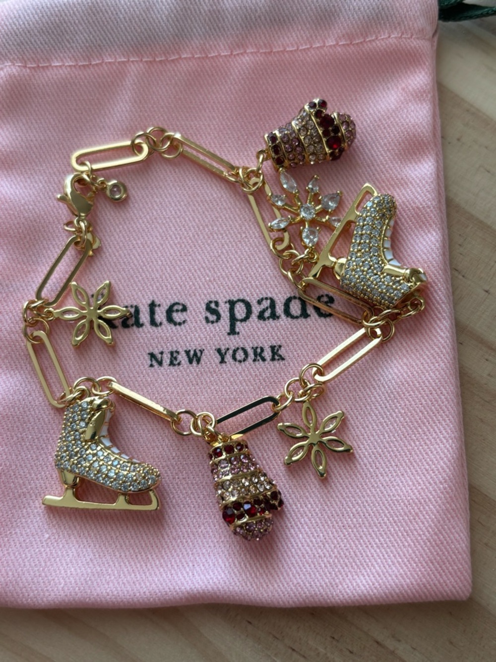 New kate spade Gold Tone Charm Bracelet with Pink and Red Crystal Accents